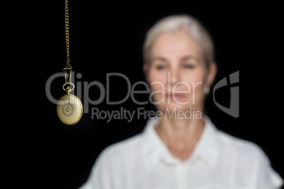 Woman being hypnotized with pendulum