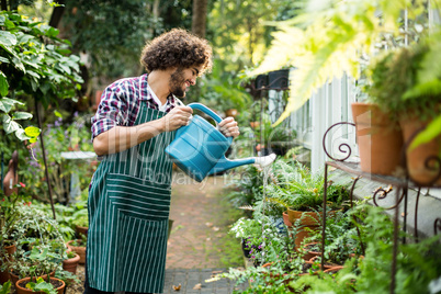 Happy gardener watering plants