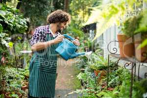 Happy gardener watering plants