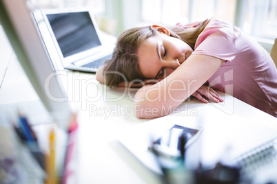 Tired graphic designer sleeping at desk