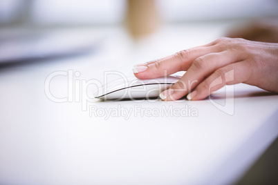 Cropped image of businesswoman using mouse at office