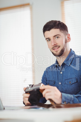 Portrait of man holding camera