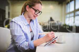 Businesswoman writing on document