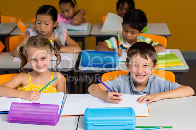 Cute classmates smiling in classroom