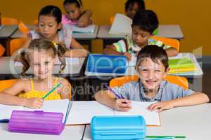 Cute classmates smiling in classroom