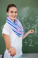 Young teacher teaching mathematics in classroom