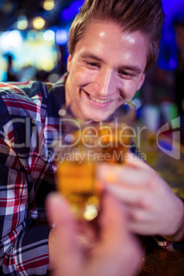 Cropped image of friend toasting with joyful man