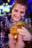 Cropped image of friend toasting with joyful man
