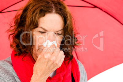 Close-up of mature woman suffering from cold