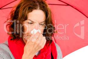 Close-up of mature woman suffering from cold