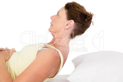 Mature woman exercising on bed