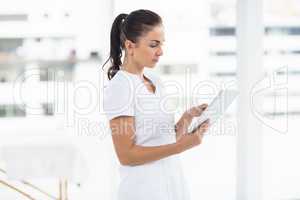 Focused woman using digital tablet