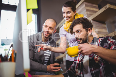 Businesswoman pointing while explaining male colleagues