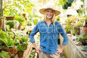 confident female gardener at greenhouse