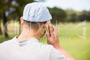 Rear view of golfer calling