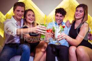 Friends toasting cocktail in nightclub