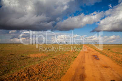 African road with clouds
