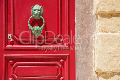 Lionhead doorknob and red door