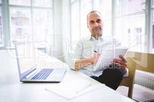 Businessman writing on document