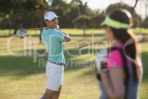 Smiling golfer man looking at woman