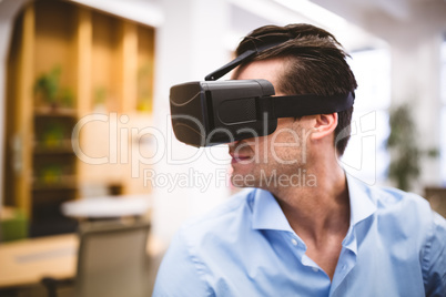 Businessman enjoying virtual reality headset at office