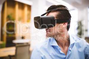 Businessman enjoying virtual reality headset at office