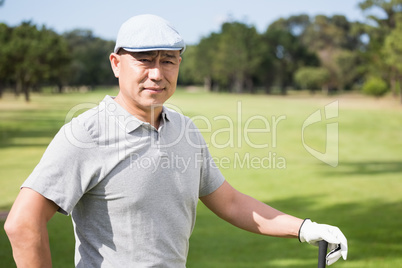 Thoughtful young man with golf club