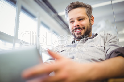 Low angle view of businessman working on laptop in office