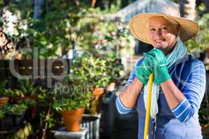 Portrait of happy mature gardener at garden