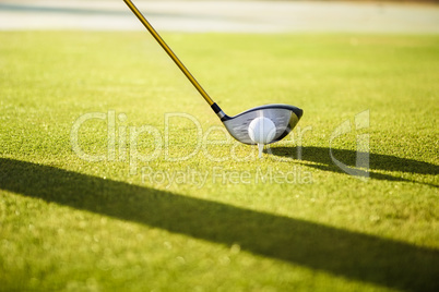 Close up of a golf ball and club