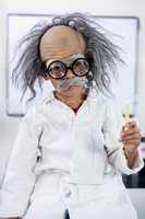 Boy dressed as scientist sitting in classroom