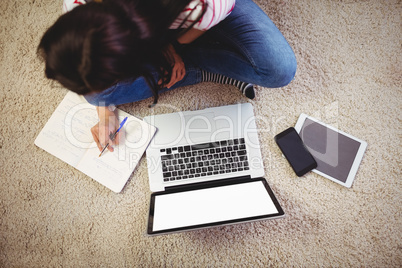 High angle view of woman with laptop on rug