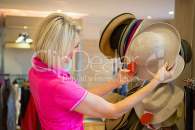 Mature woman looking a hat