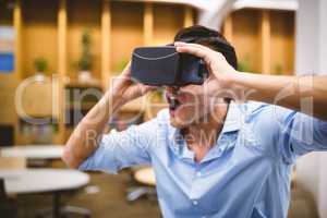 Businessman enjoying augmented reality headset at office