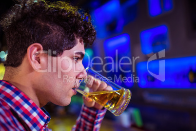 Man drinking beer in nightclub