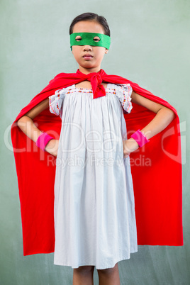 Girl dressed as superhero in classroom