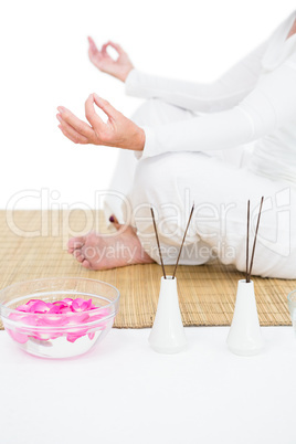 Low section of woman meditating