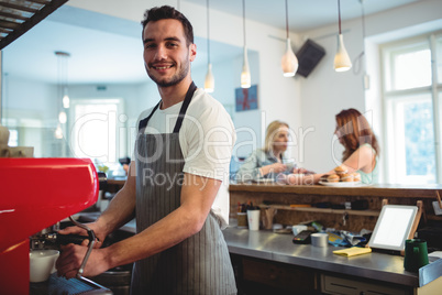 Portrait of confident barista at cafe