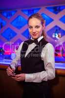 Confident young barmaid at counter