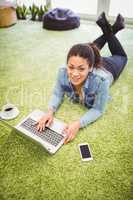 High angle portrait of businesswoman using laptop in office