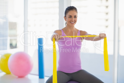 Happy woman exercising at fitness studio