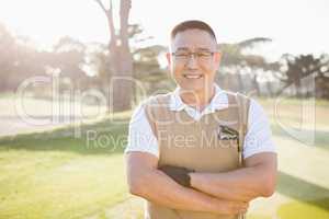 Portrait of golfer posing with his arms crossed