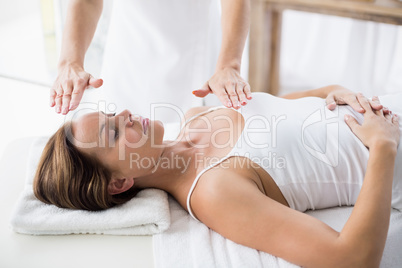 Woman receiving reiki treatment