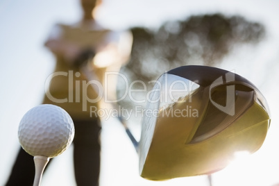 Focus on foreground of golf club and ball