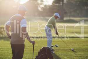 Mature golfer men standing on field
