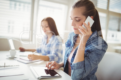 Female colleagues working at creative office