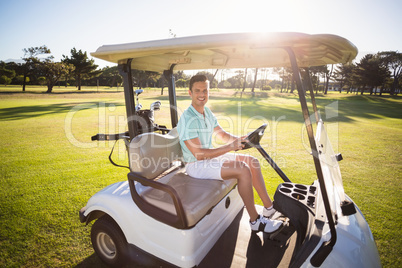 Full length portrait of man sitting in golf buggy