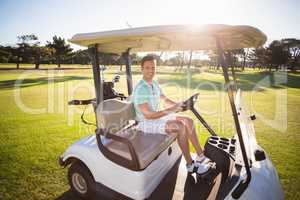 Full length portrait of man sitting in golf buggy