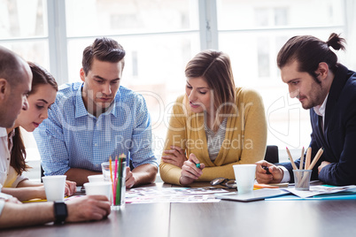 Photo editors discussing over documents