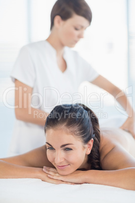 Masseuse giving massage to woman